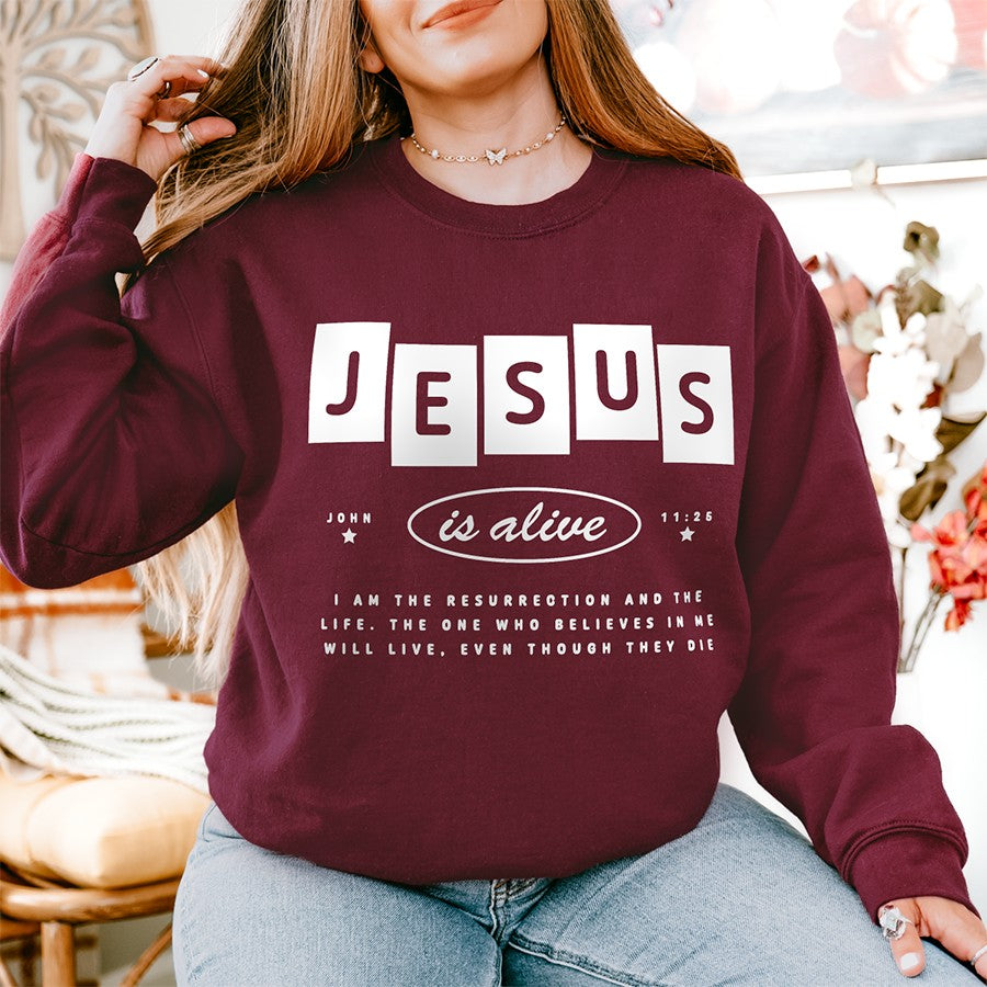 Womens Model Wearing Maroon Jesus is Alive Unisex Sweatshirt