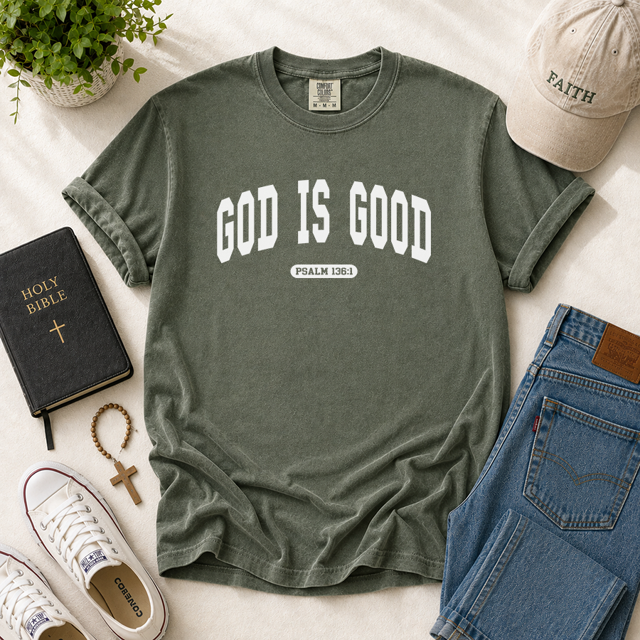 God Is Good Psalm 136:1 Christian T-Shirt in Moss – Bible Verse Shirt Flat Lay